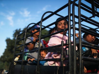 People from a caravan of Central American migrants on their way to the United States wait to depart on a truck whose driver offered a ride on January 22, 2019, in Santo Domingo Zanatepec, Mexico.