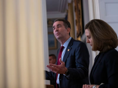Virginia Gov. Ralph Northam, flanked by his wife Pam, speaks with reporters at a press conference at the governor's mansion on February 2, 2019, in Richmond, Virginia.