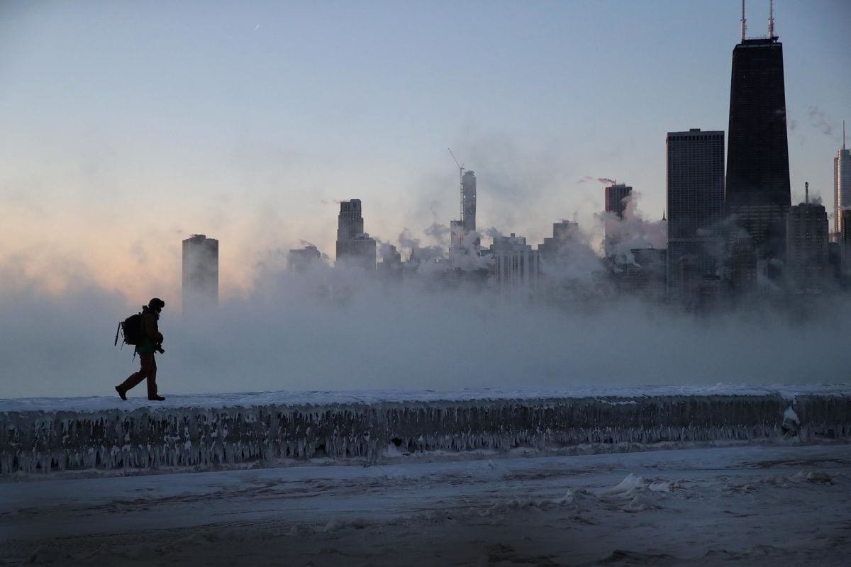 A man walks along an ice-covered breakwall along Lake Michigan while temperatures were hovering around -20 degrees and wind chills neared -50 degrees on January 31, 2019, in Chicago, Illinois.