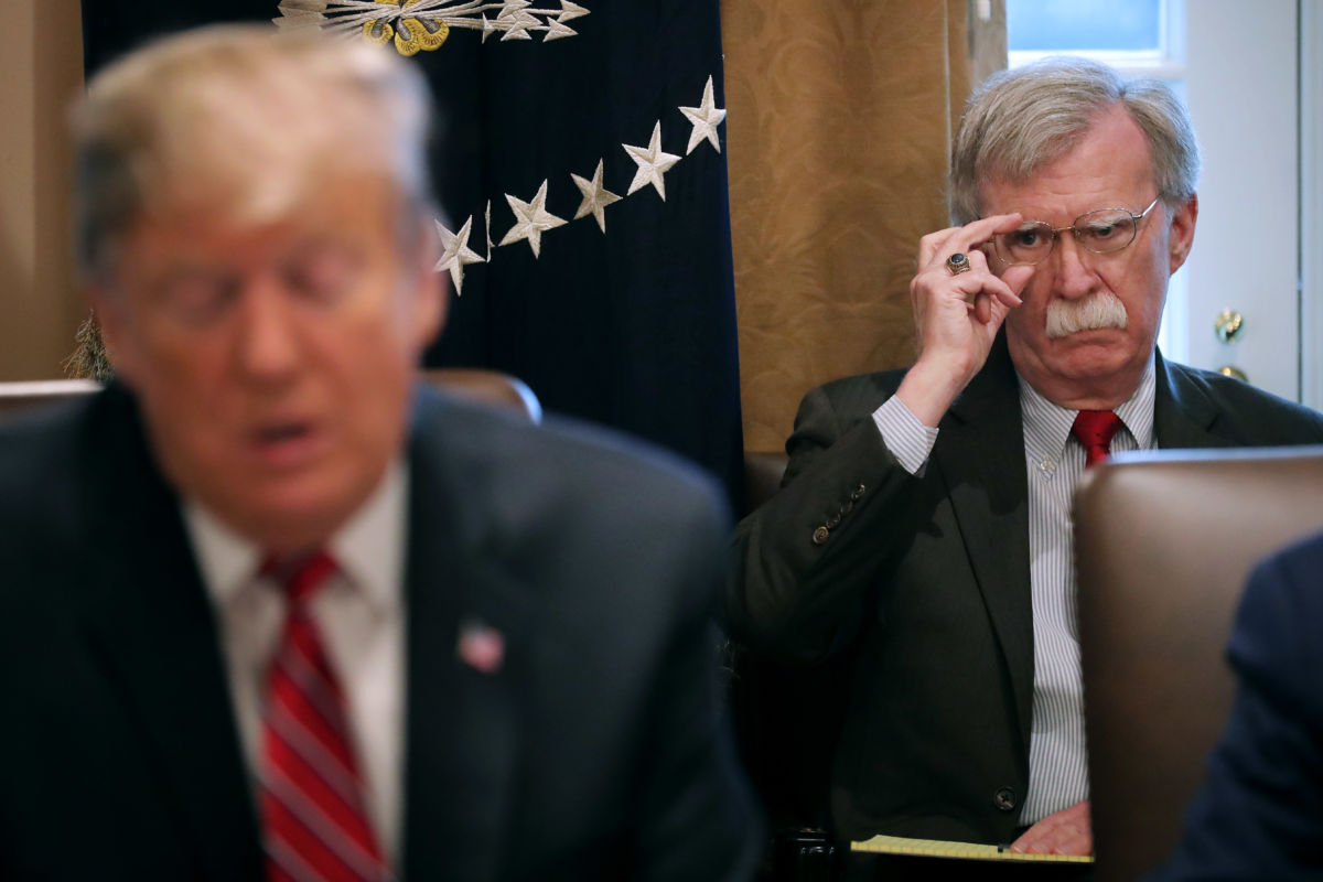 National Security Adviser John Bolton listens to President Trump talk to reporters during a meeting of his cabinet in the Cabinet Room at the White House, February 12, 2019, in Washington, D.C.
