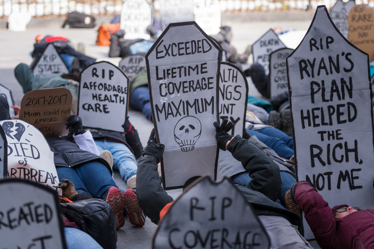 Activists gathered on March 11, 2017, near Brooklyn Borough Hall where the staged a rally and symbolic "die-in" in opposition to the repeal of the Affordable Care Act (ACA) and its replacement by Republican-authored legislation.