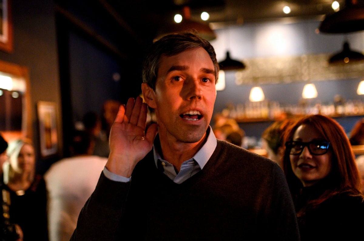 Former Texas Congressman and Democratic party presidential candidate Beto O'Rourke leans in to hear a comment after speaking to diners at The Pig & Porter restaurant in Cedar Rapids, Iowa, on March 15, 2019.