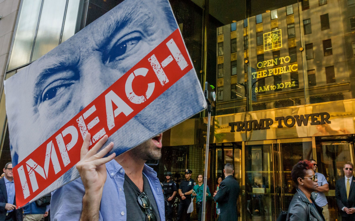 Protesters with Impeach signs rally outside Trump Tower