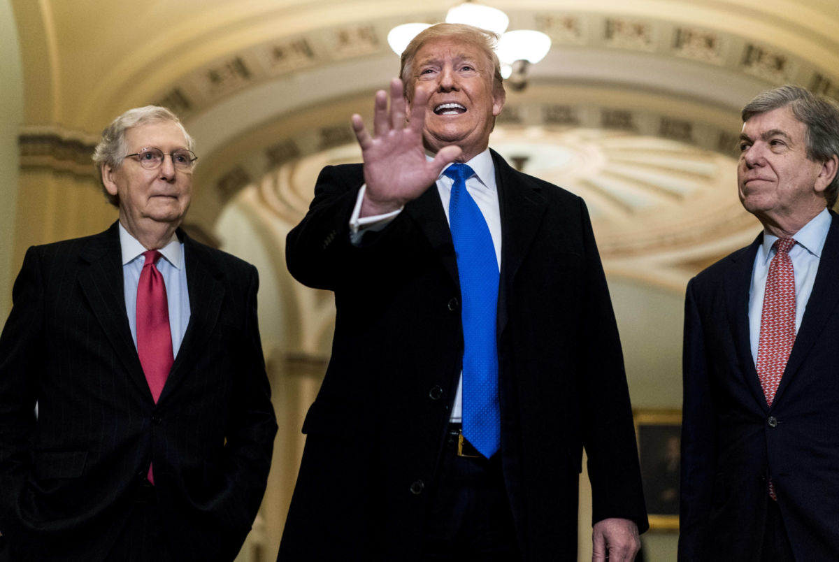 Donald Trump stands between Sens. Mitch Mcconnell and Roy Blunt
