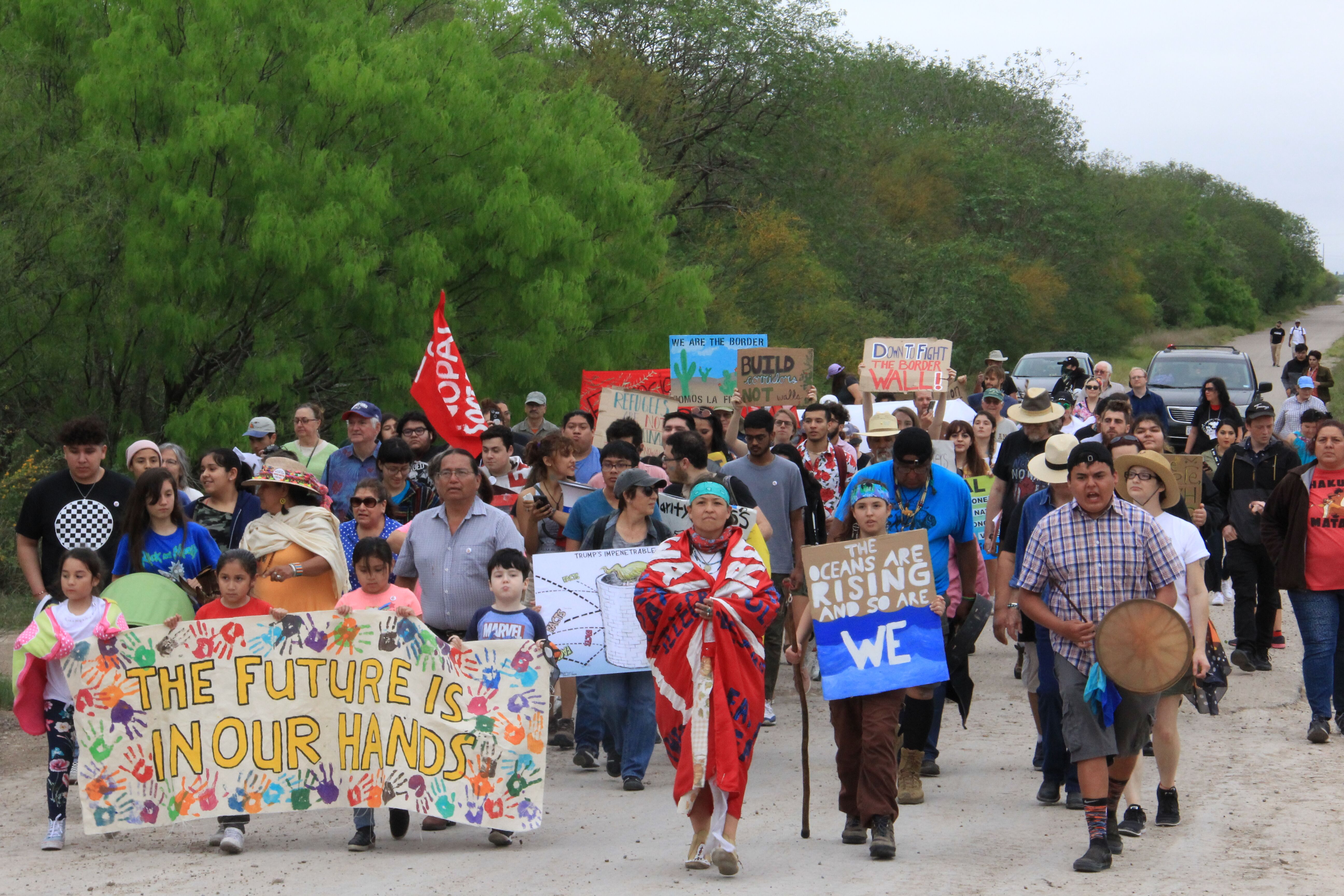 Rio Grande Valley residents, including and Native and environmental activists, march from the National Butterfly Center in Mission, Texas, toward an area where Trump’s proposed border fence is slated to go up on Sunday, March 3, 2019. The annual climate march and rally centered the border wall’s impacts on the land and wildlife in the area.