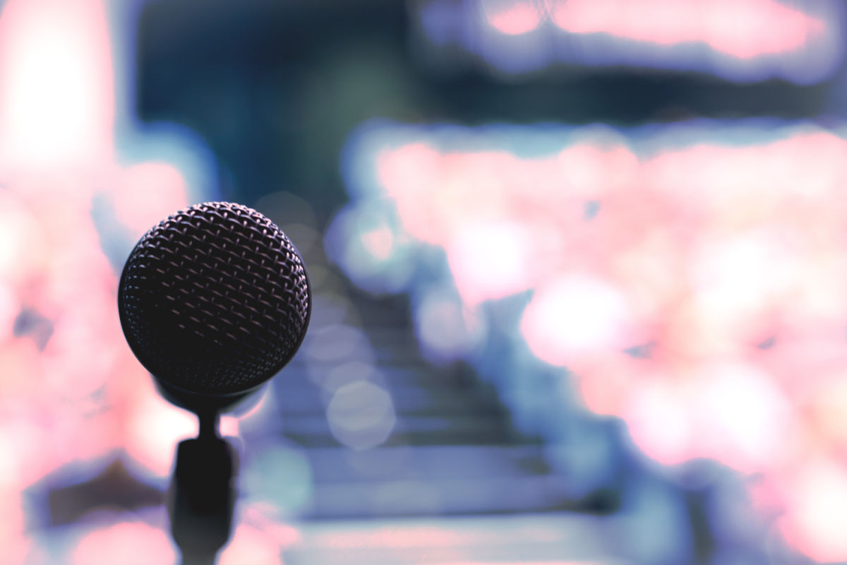 A closeup of a microphone on a podium