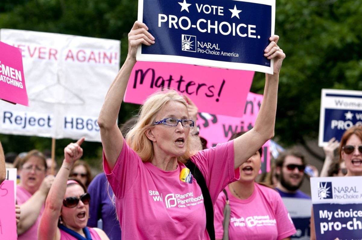 A woman holds a pro-choice sign during a large protest