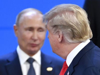Donald Trump walks by Vladimir Putin