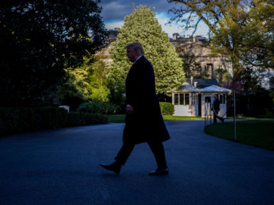 President Trump walks in shade on return to the White House