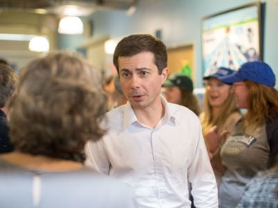 Pete Buttigieg talks to supporters in a small crowd