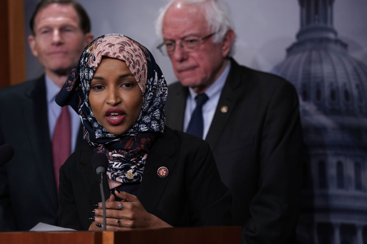 Rep. Ilhan Omar speaks into a microphone