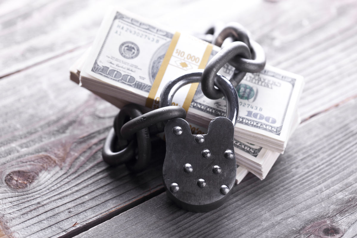 U.S bank notes are encircled with chains and a lock