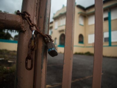 A lock over the front gate of Escuela Emilio Castelar in the Santurce neighborhood of San Juan, Puerto Rico. The school closed in the aftermath of Hurricane Maria.