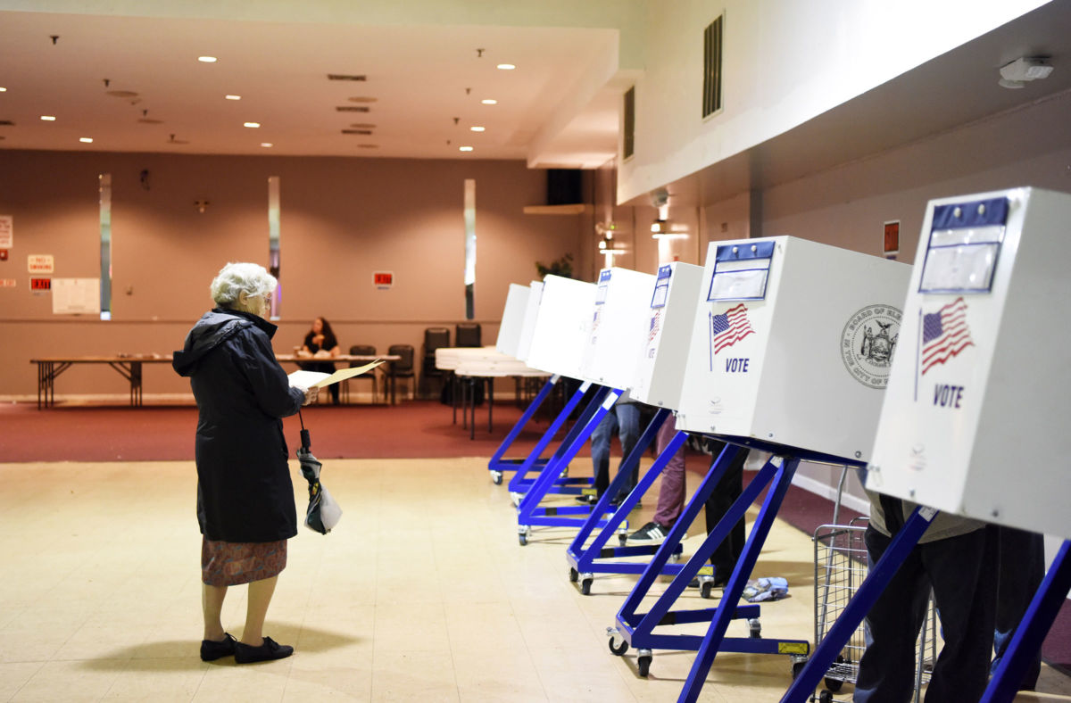 A voter walks to the booth to fill in her ballot at a polling station in Staten Island, New York, November 6, 2018.