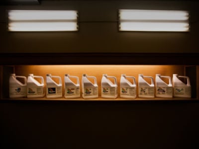 A lit display case showcases several containers of Monsanto's RoundUp