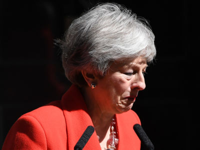 Theresa May cries while wearing a red blazer