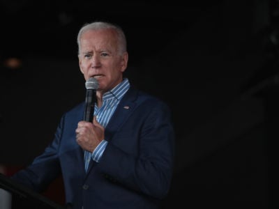 Joe Biden speaks into a microphone at a podium