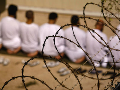 Detainees kneel during an early morning prayer at the U.S. military prison at Guantanamo Bay, Cuba, on October 28, 2009.