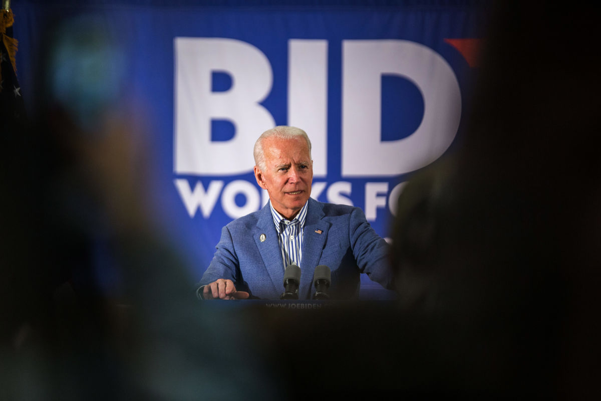 Joe Biden is seen speaking on a stage