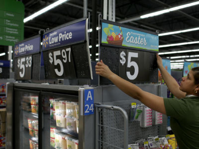 Walmart employee Yanetsi Grave works in a Walmart store on February 19, 2015 in Miami, Florida. Average Walmart workers make twice the federal minimum wage but may still qualify for public benefits.