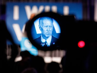 Joe Biden is seen through the viewfinder of a camera
