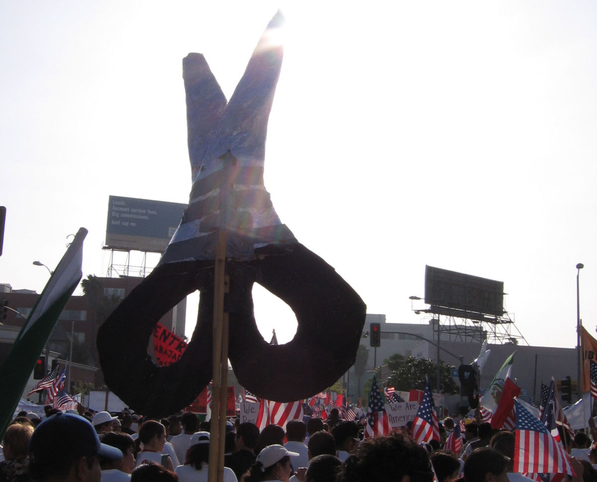 A scissors sign, representing the Garment Worker Center, is seen at a May Day march in Los Angeles, California, May 1, 2006.