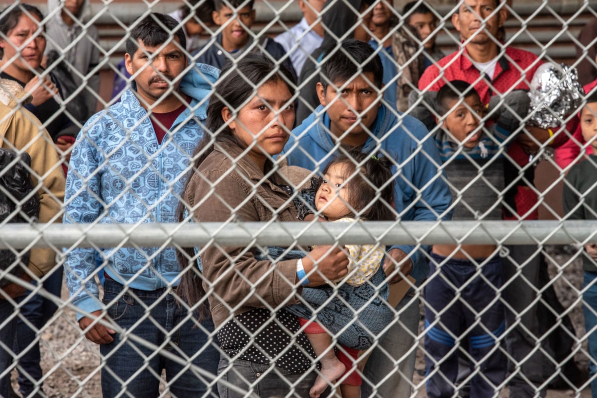 Migrants are gathered inside the fence of a makeshift detention center in El Paso, Texas, on March 27, 2019.