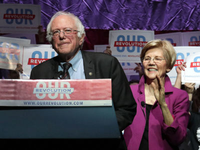 Sen. Bernie Sanders is introduced by Sen. Elizabeth Warren during a rally at the Orpheum Theatre in Boston on March 31, 2017.