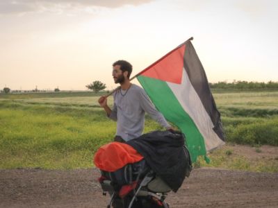 As Benjamin Ladraa walks through 13 countries, he carries a large Palestinian flag with him to raise awareness of Palestinians’ plight.