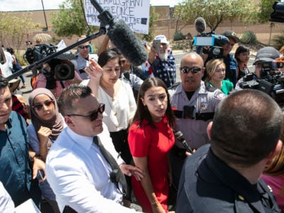 Rep. Alexandria Ocasio-Cortez is swarmed by the media after touring the Border Patrol facility housing children on July 1, 2019, in Clint, Texas.