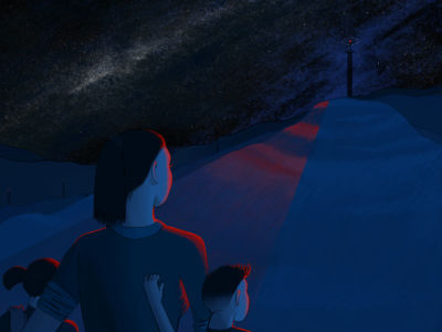 A mother and her two children are illuminated by the red light topping a radio tower