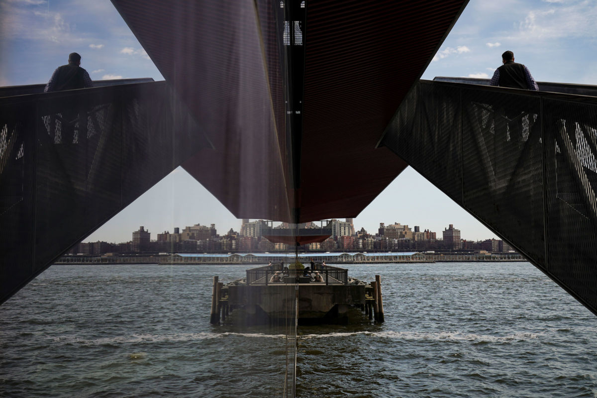 A man walks up stairs at Pier 15 along the East River at South Street Seaport, March 14, 2019 in New York City. Mayor Bill de Blasio has unveiled a $10 billion plan to extend the Lower Manhattan coastline by up to two city blocks to guard against rising sea levels and other effects of climate change.