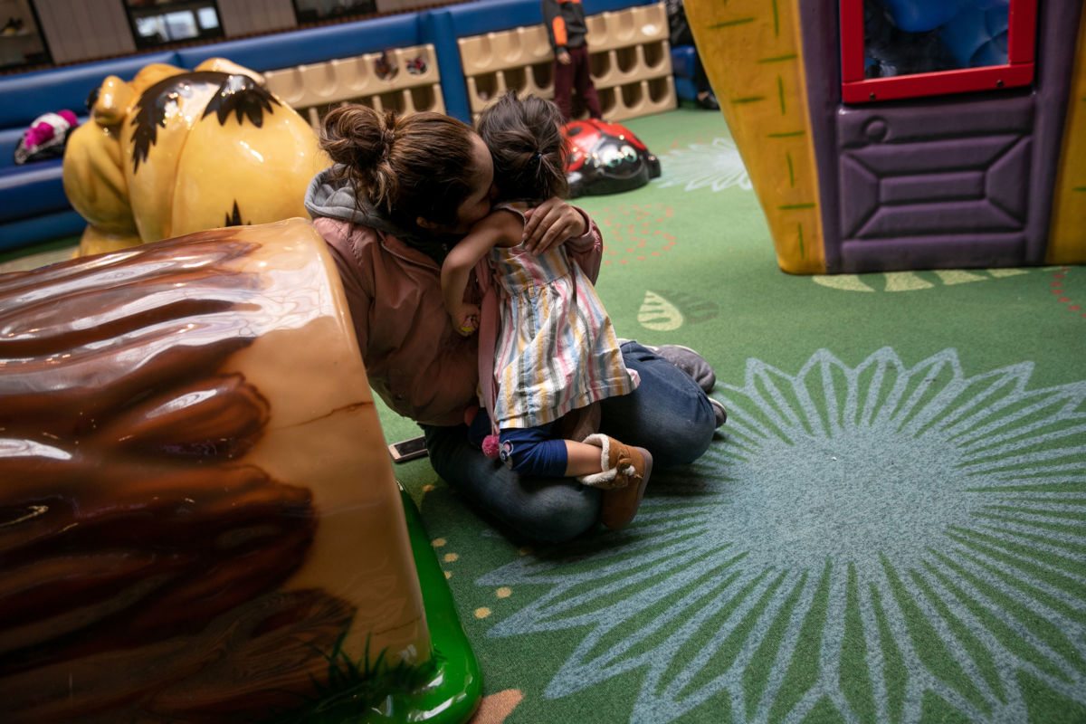 Honduran asylum seeker Sandra Sanchez embraces her two-year-old daughter Yanela Sanchez at a playground on February 13, 2019, in the greater Washington D.C. area.