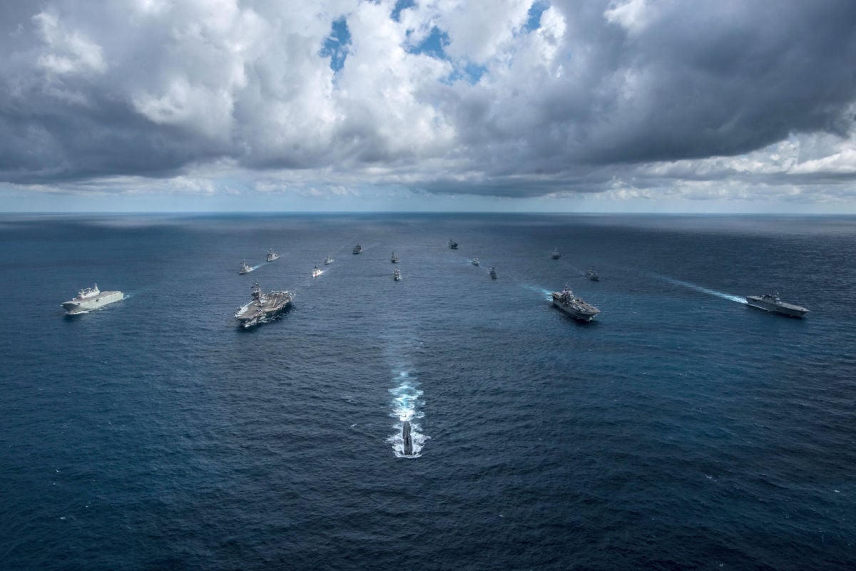 Naval ships sail in formation