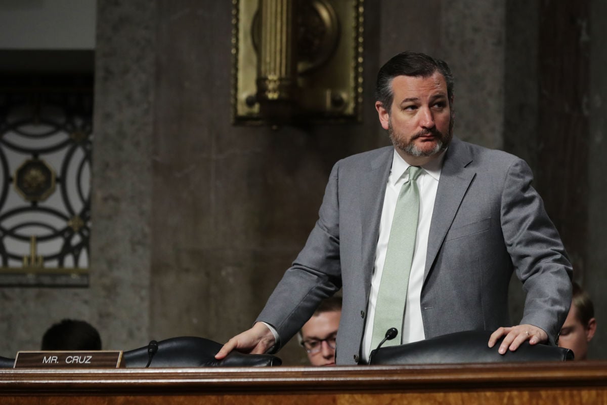Sen. Ted Cruz stands up from a chair