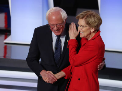 Bernie Sanders and Elizabeth Warren embrace while smiling