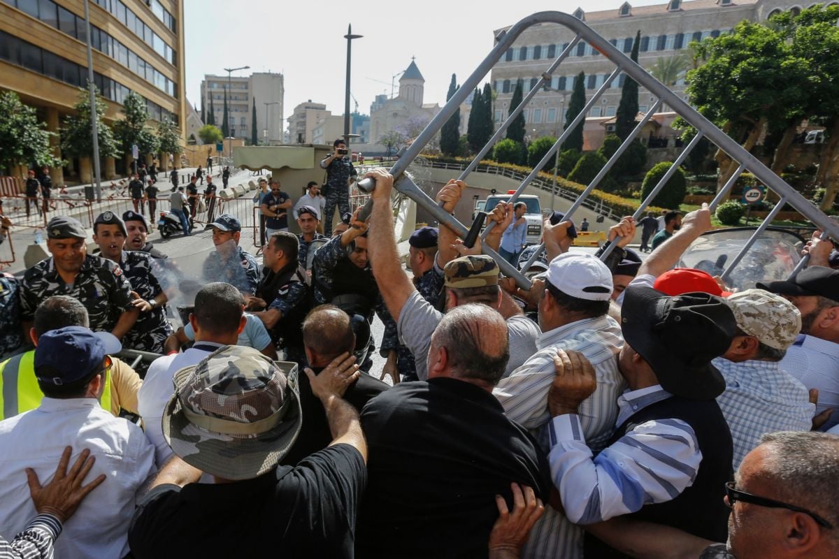 Lebanese retired security personnel remove a barricade during a demonstration over feared pension cuts near the government's headquarters in the capital Beirut on May 20, 2019.