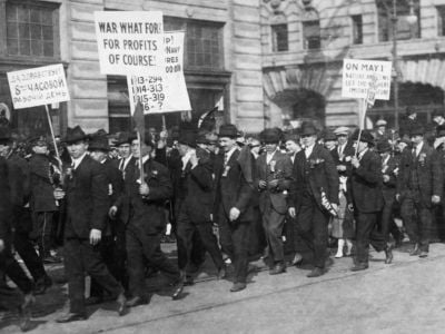 Antiwar demonstrators carrying placards in the May Day parade on January 1, 1916. People who opposed WWI were prosecuted by the hundreds and faced assault by vigilante groups.
