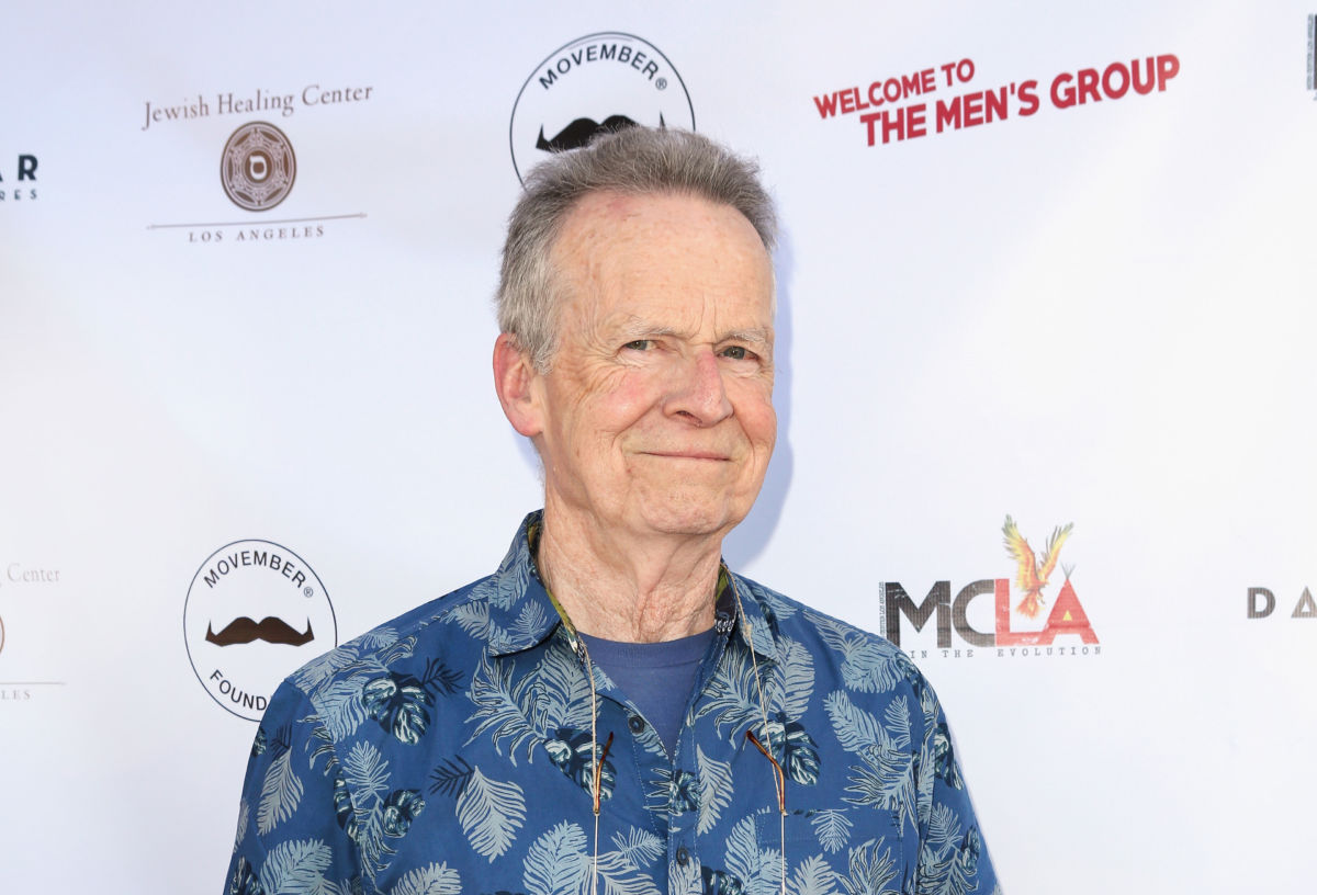 Actor David Clennon smiles while wearing a blue shirt