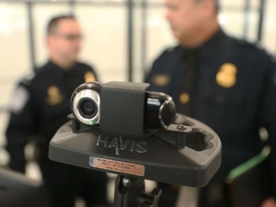 U.S. Customs and Border Protection officers use a facial recognition device at Miami International Airport to screen travelers entering the United States on February 27, 2018, in Miami, Florida.