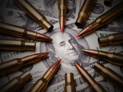 Bullets encircle the face of Benjamin Franklin on a $100 bill