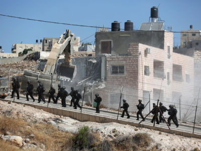 Israeli soldiers supervise the demolition of buildings belonging to Palestinians on the grounds that they are too close to the wire barriers that continue the separation wall in the Wadi al-Hummus neighborhood of East Jerusalem, July 22, 2019.