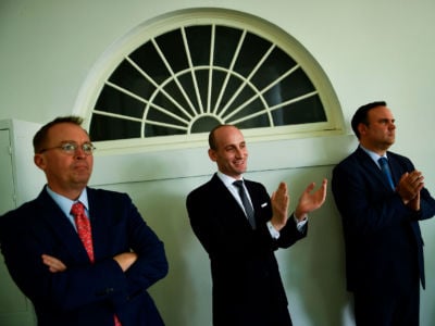 White House acting Chief of Staff Mick Mulvaney, Presidential Adviser Stephen Miller and White House Social Media Director Dan Scavino listen as President Trump announces an immigration proposal in the Rose Garden of the White House in Washington, D.C., on May 16, 2019.