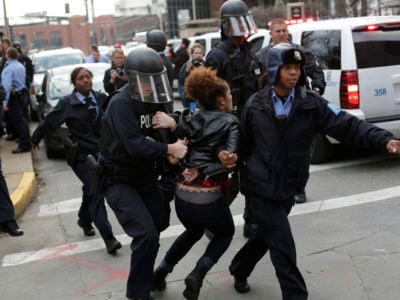 A woman is dragged away by cops during a Black Lives Matter protest