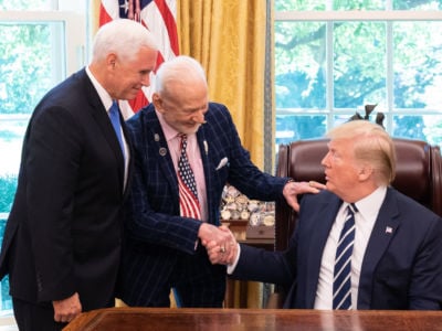 Former astronaut Buzz Aldrin shakes President Trump's hand as Vice President Pence watches.