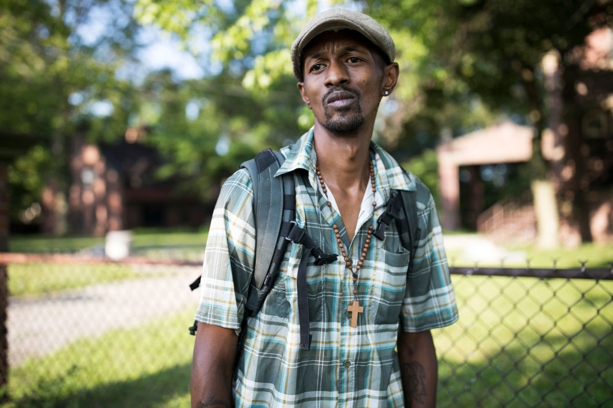 Trenton Burrell, who was diagnosed with hepatitis A, stands in Akron, Ohio, on July 23. Burrell, who used to live in a tent but now stays at a friend’s house, believes he contracted the virus while cleaning up trash left by fellow drug users and not wearing gloves. Burrell now warns others to be careful of the dangers of touching dirty needles or other trash, and he spreads the word about vaccination.