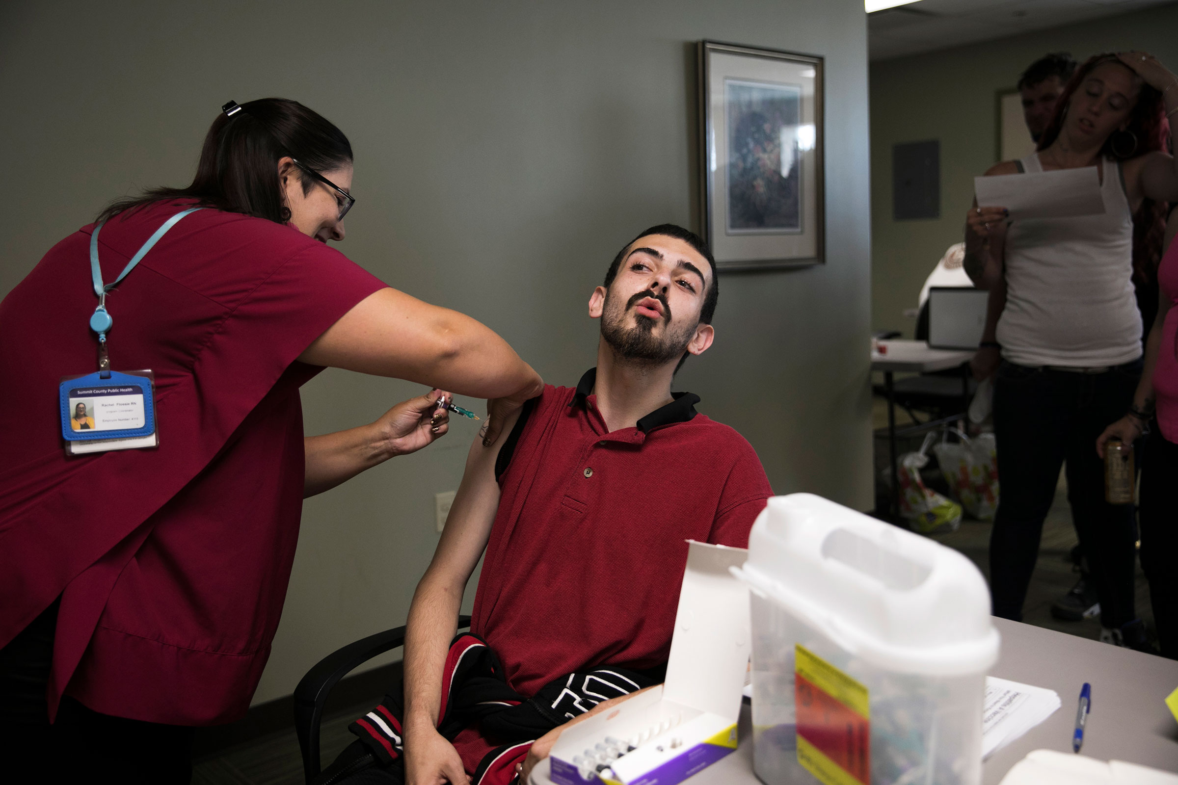 Summit County Public Health nurse Rachel Flossie gives a hepatitis A vaccination to Robert Wolf, 24, during a South Street Ministries program in Akron, Ohio.