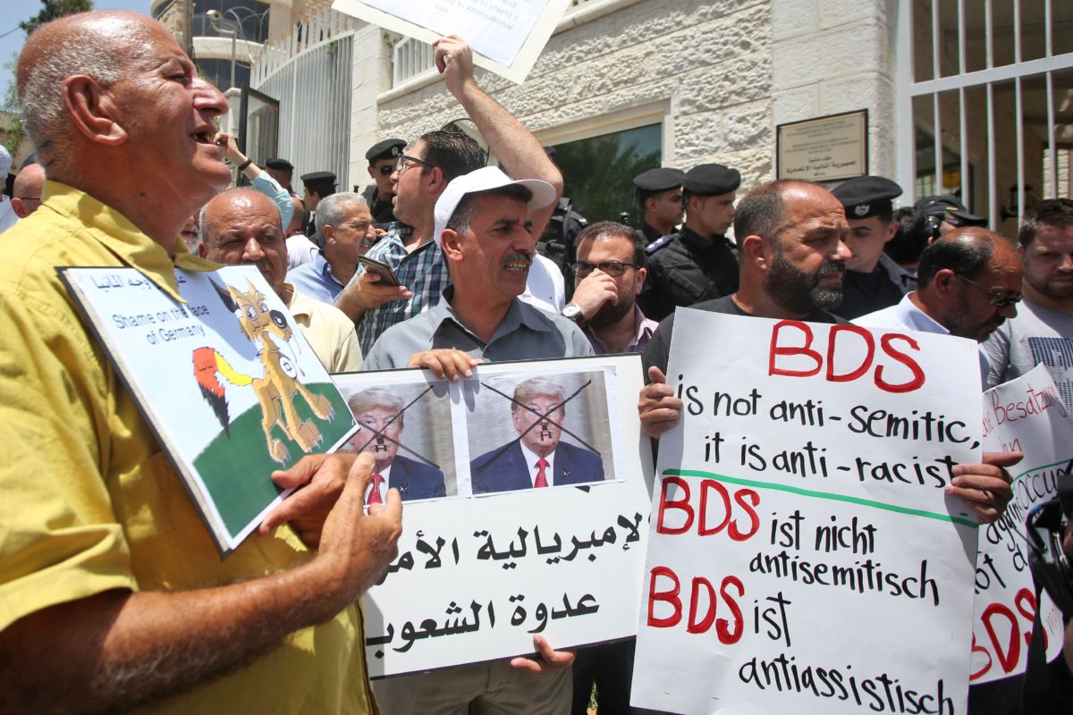 Protesters stage a demonstration outside Germany's Representative Office in Ramallah in the Palestinian West Bank on May 22, 2019, following the Bundestag's (German parliament) condemnation of the Boycott, Divestment, Sanctions (BDS) movement as anti-Semitic.