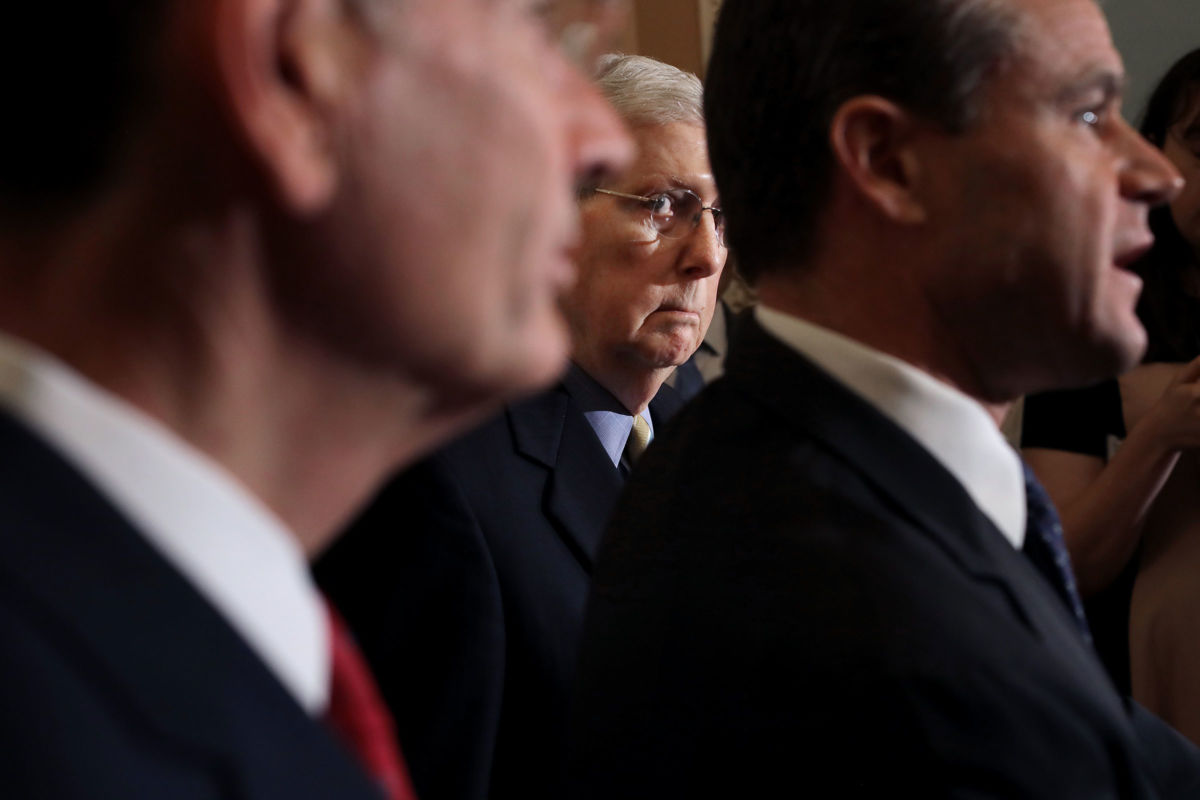 Senate Majority Leader Mitch McConnell (C) joins Sens. John Barrasso (L) and Todd Young while talking to reporters following the weekly Senate policy luncheon at the U.S. Capitol June 11, 2019, in Washington, D.C.