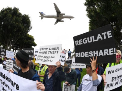 Rideshare drivers for Uber and Lyft stage a strike and protest at the LAX International Airport in Los Angeles, California, on May 8, 2019.